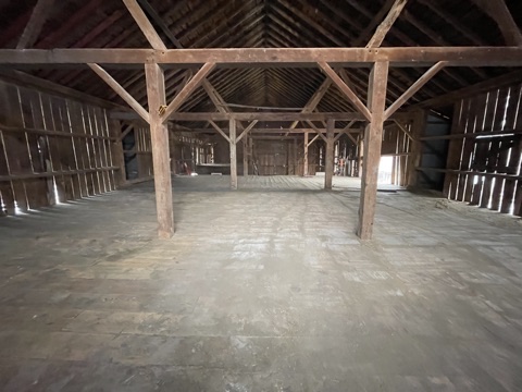 Empty barn loft with exposed wood framing
