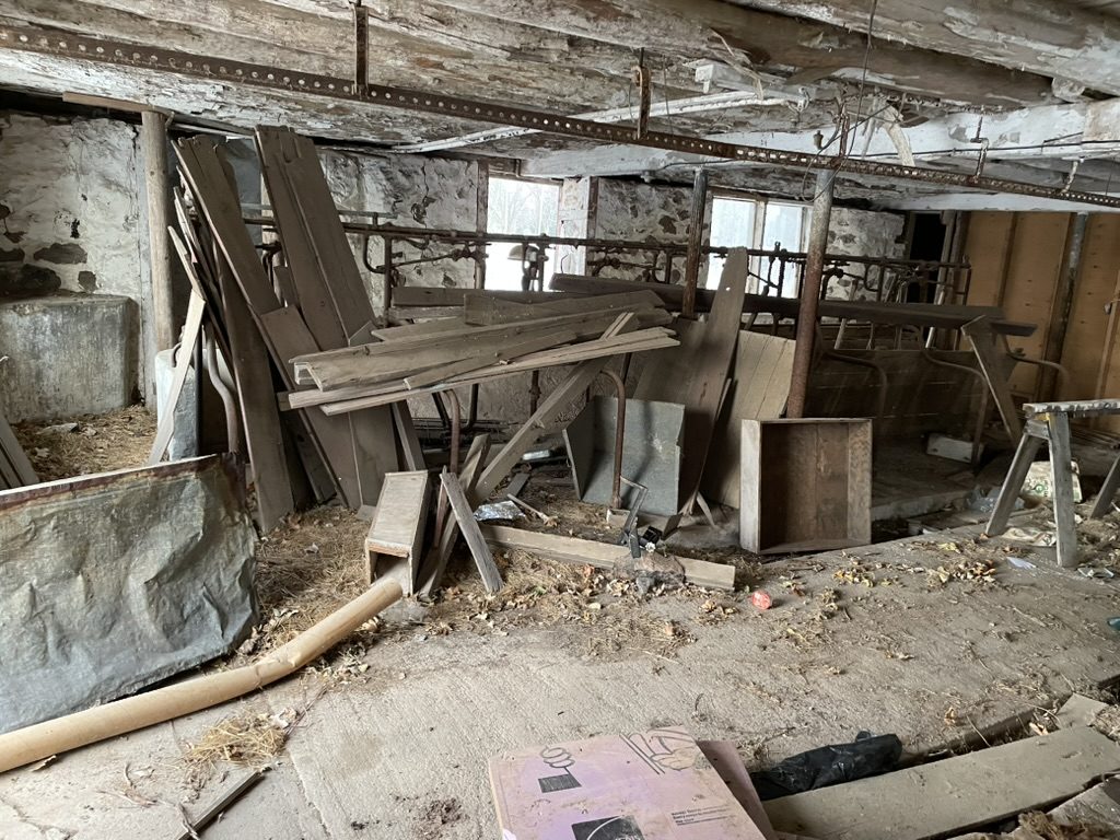 Old interior space with lumber, metal, and loose material.