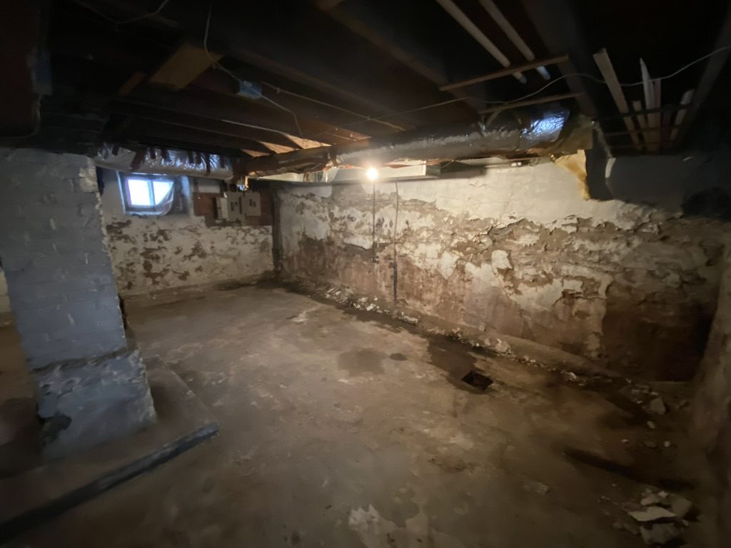 Empty old interior room with exposed walls.