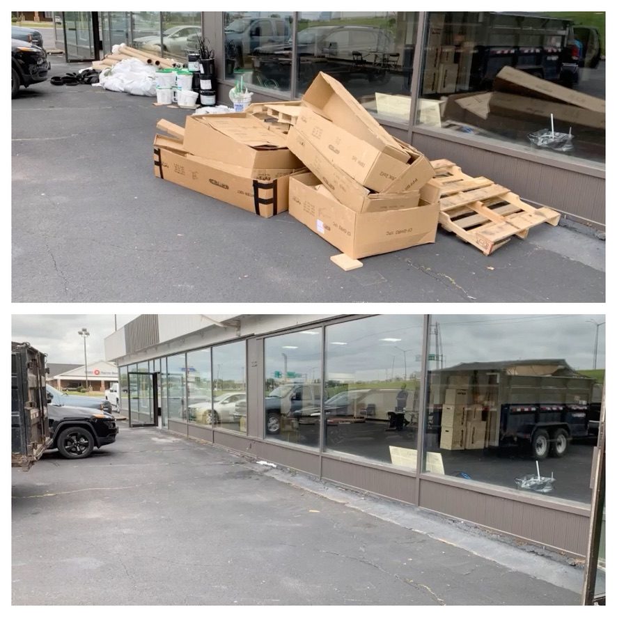 Boxes and wooden pallets outside a commercial building.