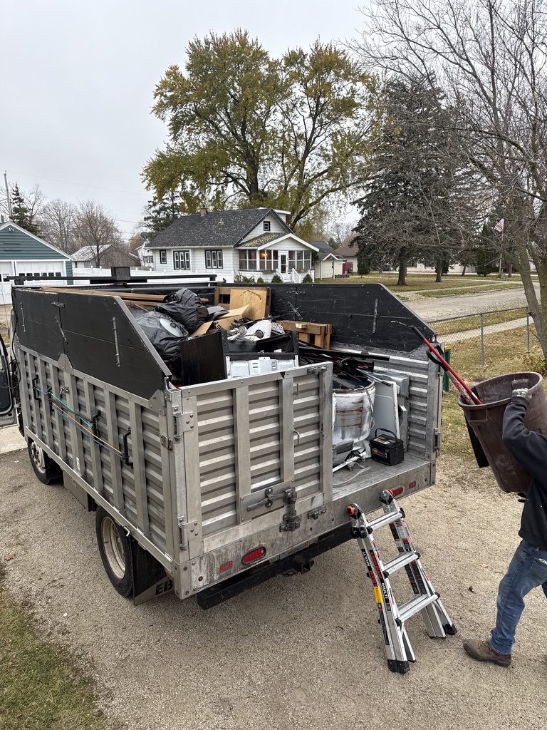 Clear The Clutter truck loaded with household junk at a customer job
