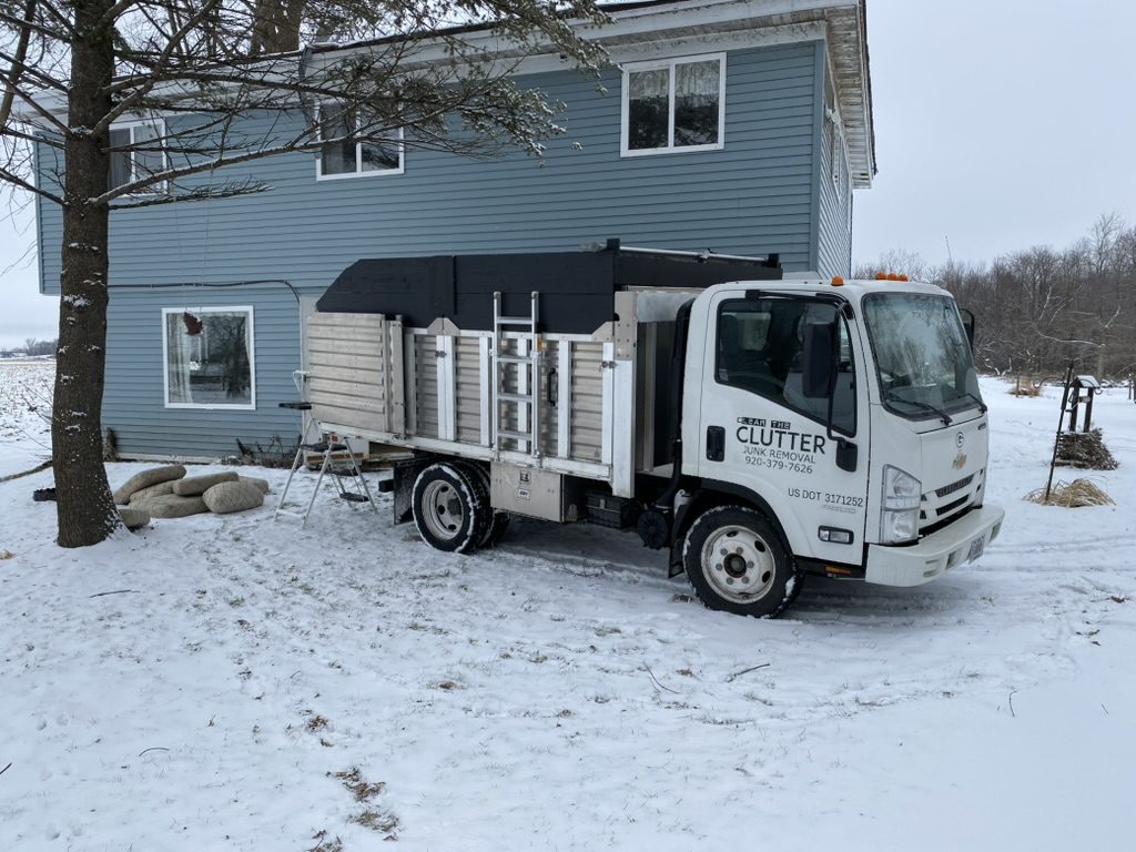 Clear The Clutter truck parked in a snowy driveway