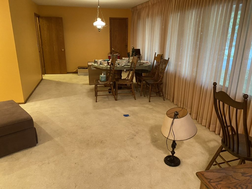 Dining area with a table, chairs, and other furniture.