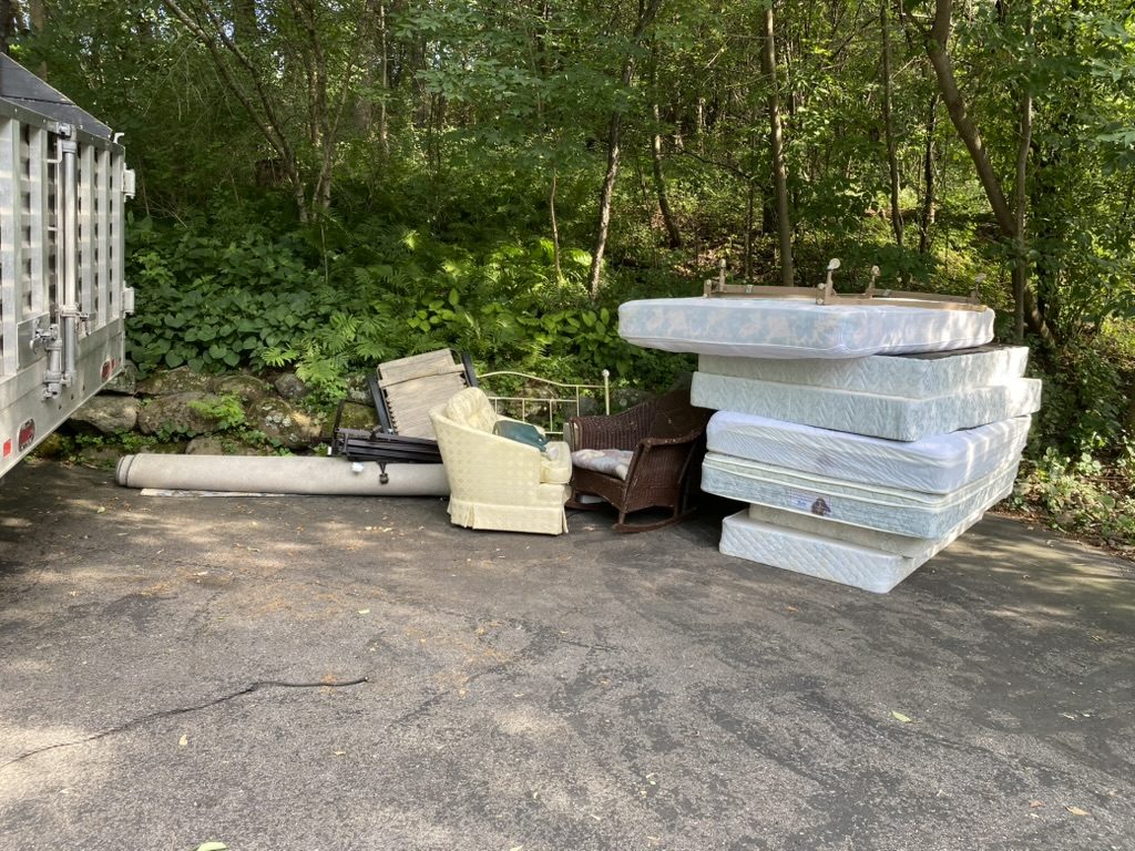 Mattresses and furniture placed outdoors.