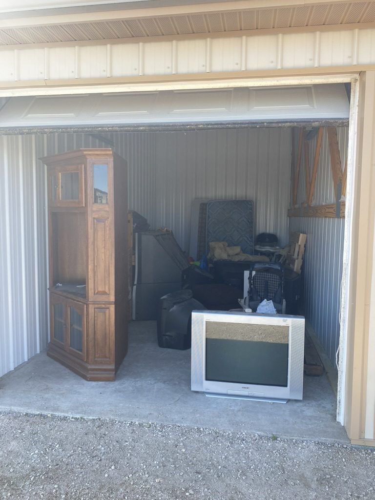 Storage unit containing furniture and a television
